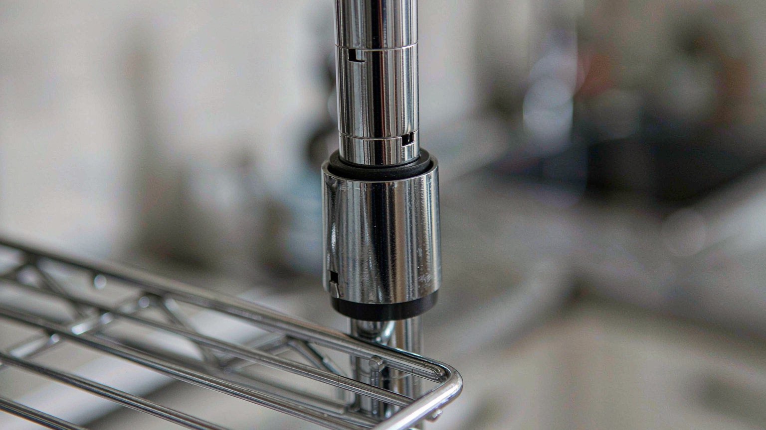 Close-up of a wire shelf collar clip on the ribbed shelf post