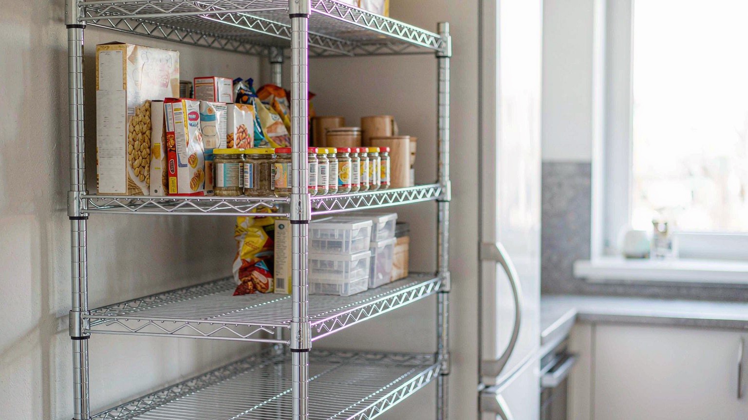 Five-tier chrome wire rack in a kitchen pantry